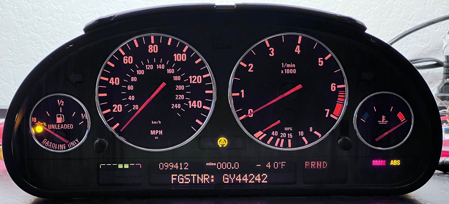 Car dashboard with illuminated gauges and indicators on a light gray background