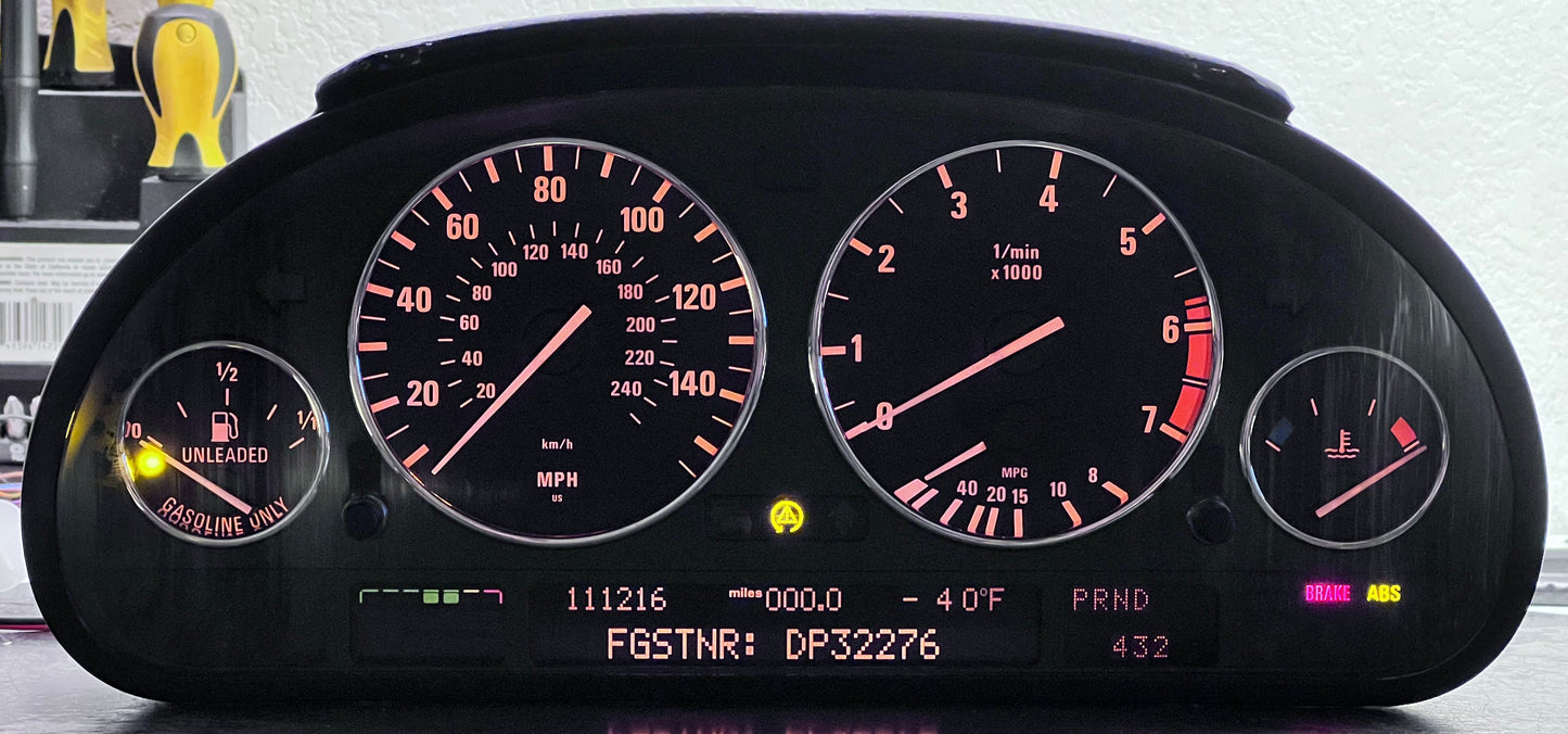 Car dashboard display with illuminated gauges on a reflective surface