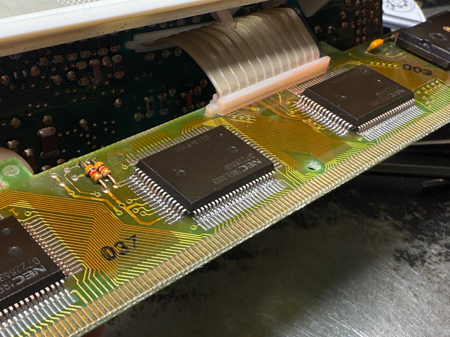 Close-up of a computer motherboard with visible chips and circuitry.