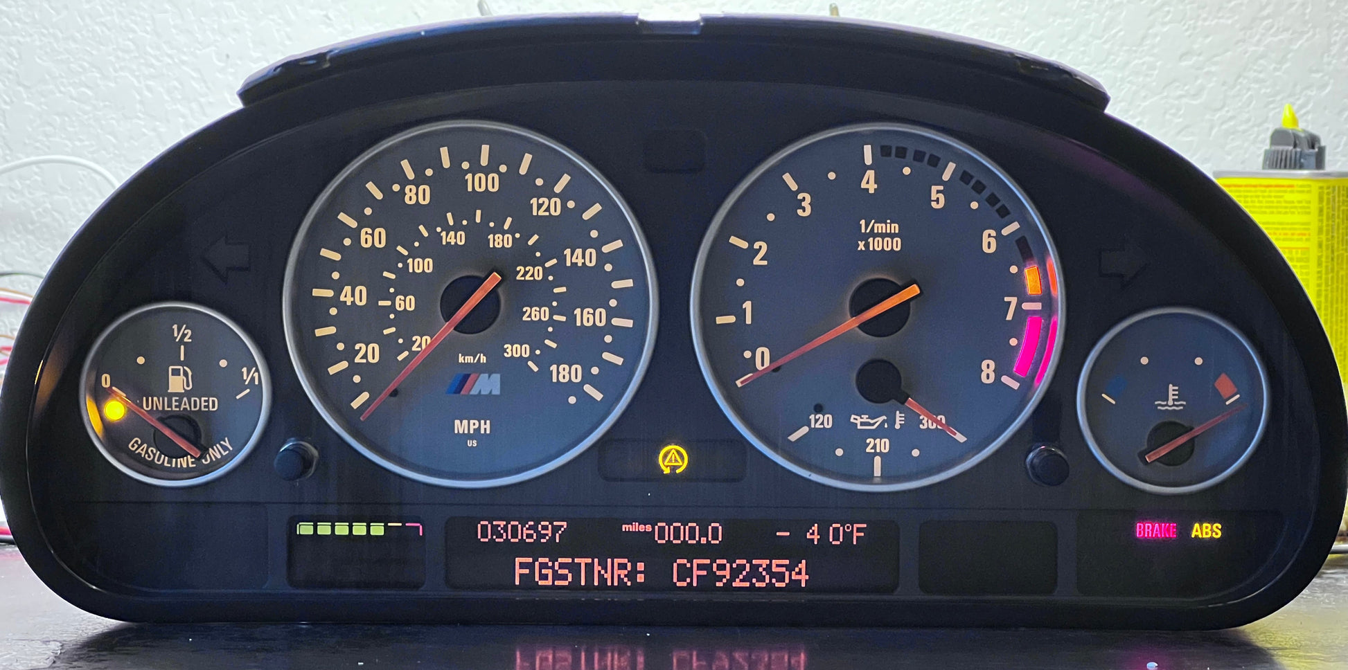 M5 dashboard with various gauges and indicators on a reflective surface.